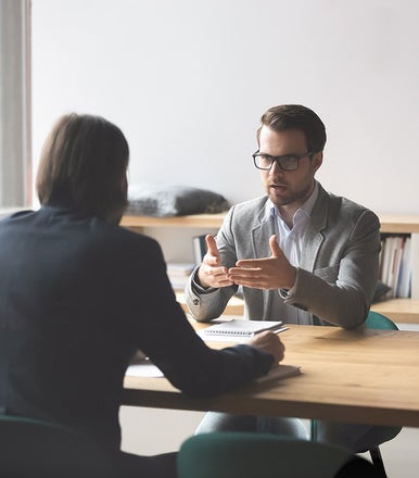 A man in a suit talking to a woman