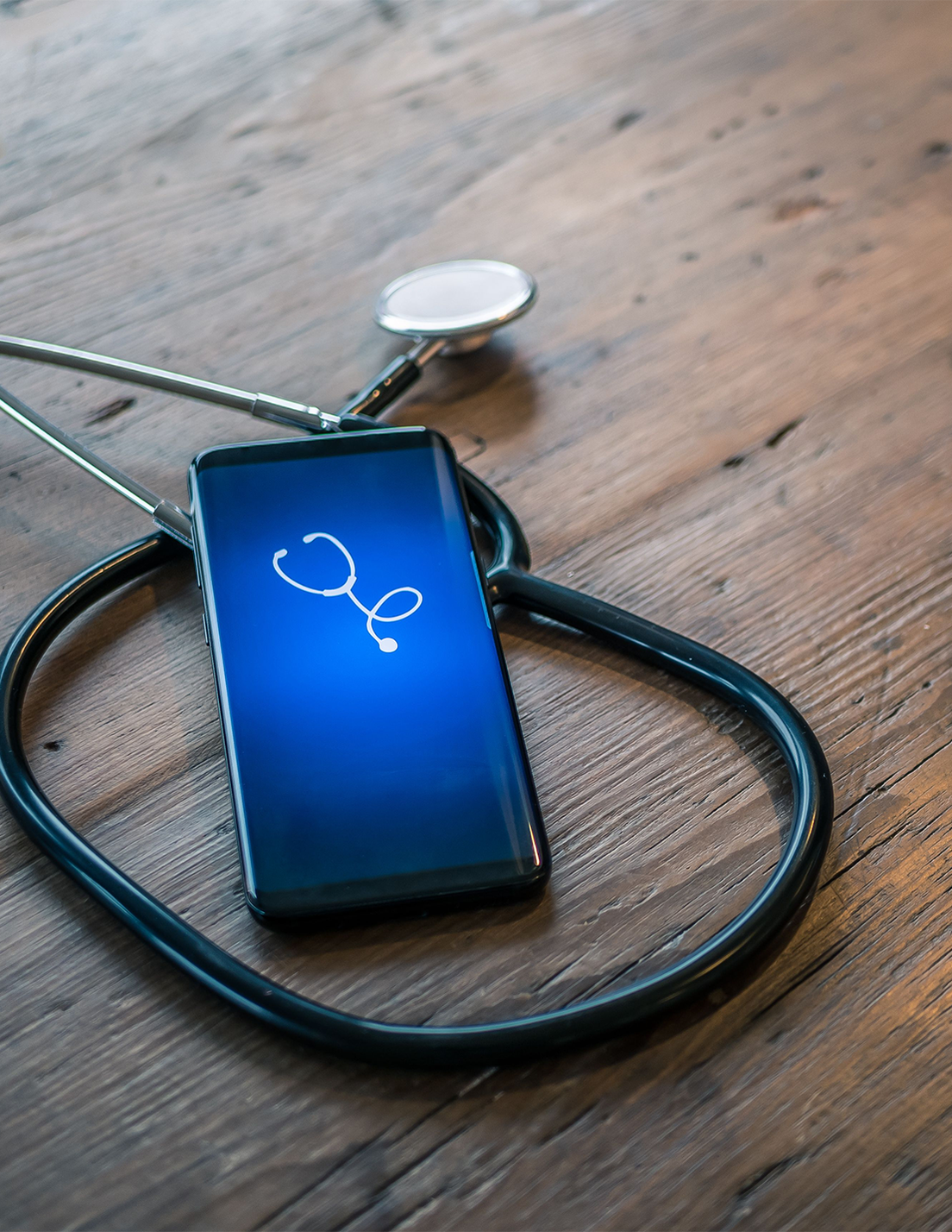 A cell phone with a stethoscope on it