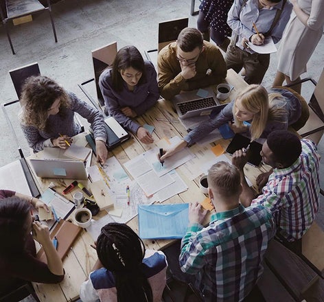 A project meeting around a table in an office setting.